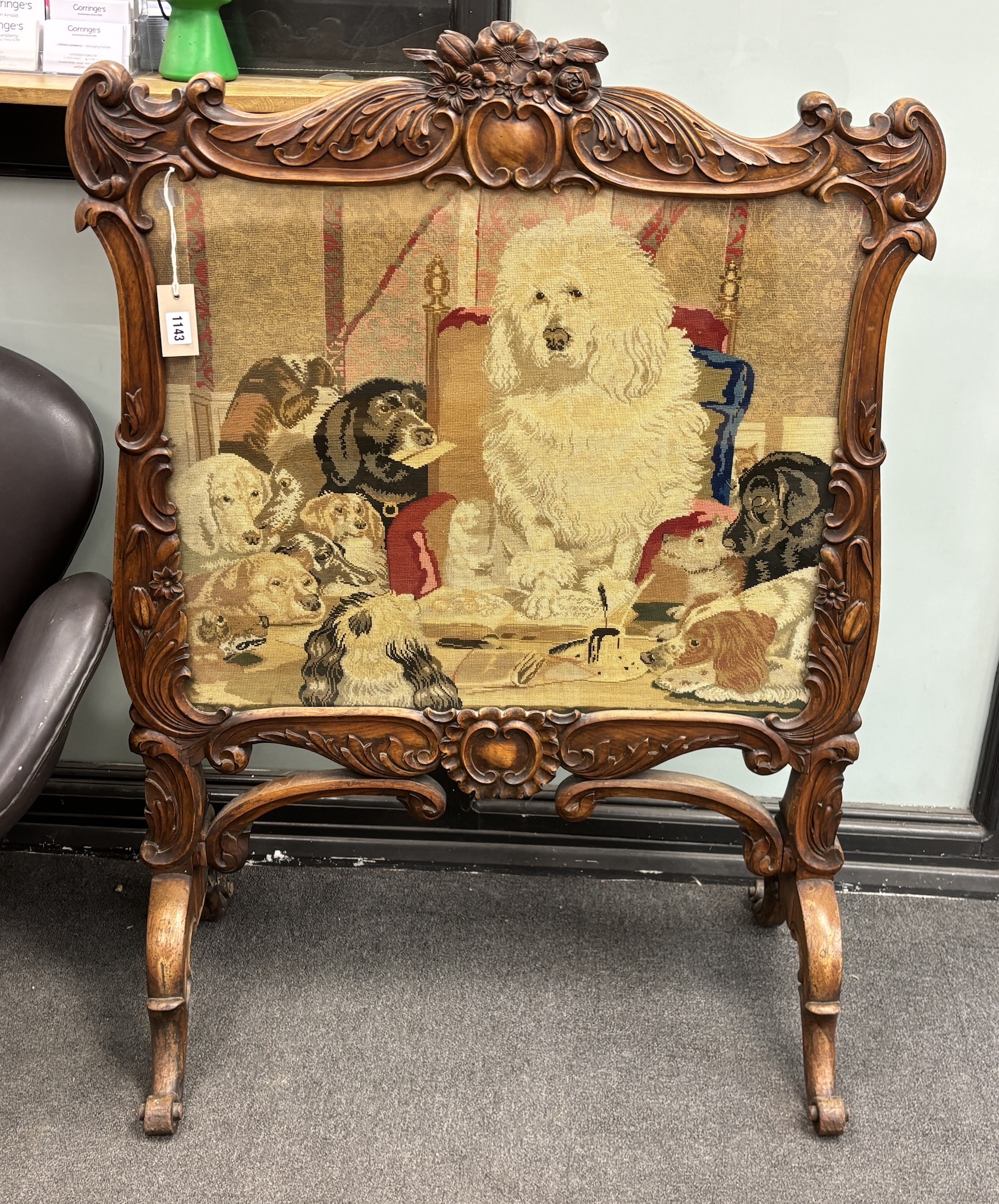 A Victorian carved walnut firescreen, worked with a scene after Landseer, width 84cm, height 113cm, Provenance: Same owner since early 20th century, commissioned for the Grace family